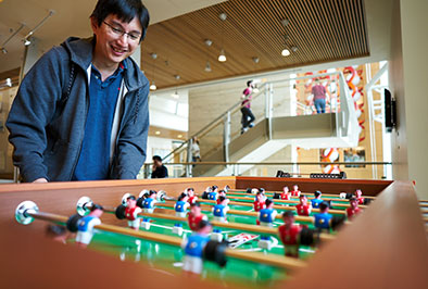 Photo of a man playing foosball. Links to Tangible Personal Property. property.jpg