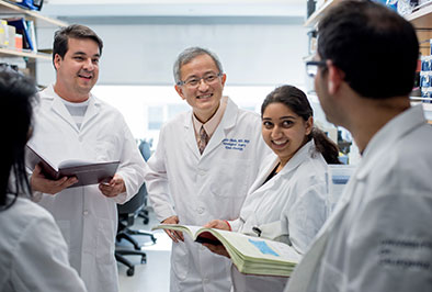 Photo of Dr. Okada and colleagues. Links to Closely Held Business Stock. stock.jpg